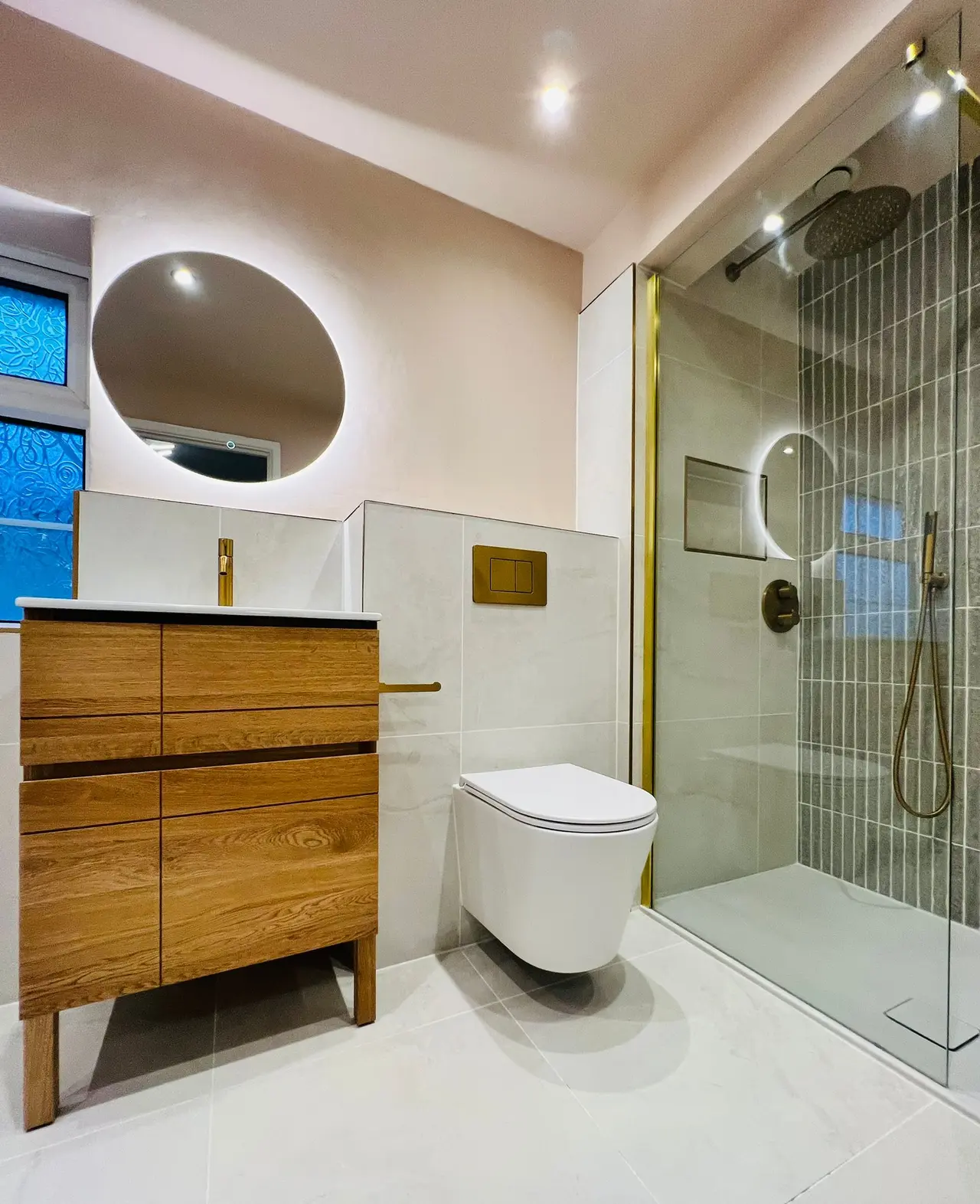 Completed bathroom renovation with oak vanity, walk-in shower and brushed brass details by AGUK Bathrooms